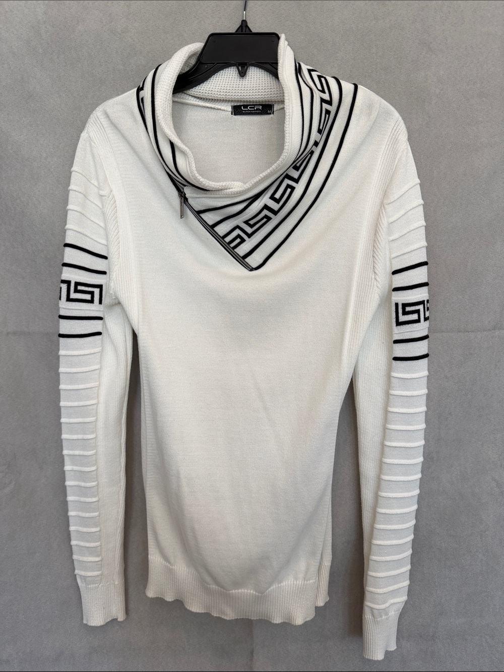 White Zip Cowl Neck Sweater with Black Geometric Trim.